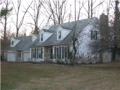 Center hall traditional: Living rm right, dining rm left, kitchen breakfast back left, beamed ceiling fireplaced family room back right.
Four beds & two bath up. Bonus rm above extra garage. Wooded site surrounds patio to back. See seller financing