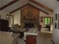 Living Room: Car siding on vaulted beamed ceiling in great living room. Raised hearth masonry fireplace w gas logs. Open access to kitchen breakfast area. Alcove right for lakeside dining view.