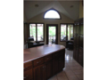 Breakfast Area/Room: Hearth rm / breakfast family dine area. Passage to deck & dock. East view to open lawn and full bay lake frontage. Clearstory glass in vaulted area captures natural light for plants and people.