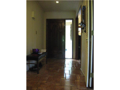 Entry: Mahogany carved entry door onto ceramic tiled flooring. Entry porch under roof cover. Natural light from open staircase to walkout basement. Center hall interchange. V grooved painted wall paneling accents stained woodwork with solid panel doors. C