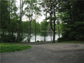 Waterfront: Home walk out to lake on east side. However, the view is two sided. West view across driveway and lake common area adjacent. Mature yard trees and surround estate homes 