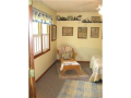 A lakeside guest bedroom has plenty of wall space for furnishings.
