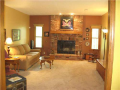 Floor to ceiling brick fireplace with raised seating hearth accent tall ceiling height in lower level walkout social area. How many rooms are there is this spacious home? Plenty. Add your label and personal furnishings to adapt the home to your family
