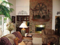 Masonry brick fireplace w seat hearth. Wet bar pass through. French doors exit to timber back deck. Two story ceiling.