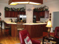 Cherry hardwood floors, stainless appliances, Corian c-tops with inlay, real wood cabinets, pantry, indirect lighting, & nice woodwork from casing to crowns.
