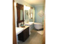 Hard surface ceramic flooring. Dual pedestal sinks. Corner claw-foot soaking tub. Separate shower and water closet area. Walk-in closet is first accessible to bed and also to the bath without walking through the bathroom