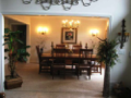 Formal dining off entry foyer. Invitational to living rm guest. Circular plan for kitchen access, but removed and private from visible or kit work area. Natural light front view to landscaped entry gardens. Ceiling sculpture.