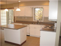 Nice lineal footage of kitchen counters. Very light and functional. Center island, butler's pantry to dining, lateral space to sides of sink and cooktop. Glass slider from breakfast area to exterior concrete patio.