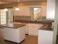 Nice lineal footage of kitchen counters. Very light and functional. Center island, butler's pantry to dining, lateral space to sides of sink and cooktop. Glass slider from breakfast area to exterior concrete patio.
