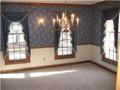 Stained woodwork to include crown, chair railing, wide window casings, decor drapery rods, coordinate wall sconce fixtures with table hanging fixture, panel moldings, traditional wall paper, textured ceilings, all add elegance to dine experience