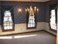Stained woodwork to include crown, chair railing, wide window casings, decor drapery rods, coordinate wall sconce fixtures with table hanging fixture, panel moldings, traditional wall paper, textured ceilings, all add elegance to dine experience
