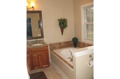 Bathroom2: Tiled floor, tub / shower fiberglass, molded marble lavatory, oval mirror, all brushed nickel fixtures for electrical, bath, and doors. Hall bath serves bedrooms adjacent in hall passage. Master bed and bath separated on west end of home