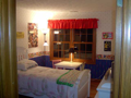 Bedroom 3: Rear loaded view via two wide window. Hardwood floors. Walk in closet.