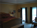 Upper level master has both tiled bath shower and platform tub with walk in closet area, plenty of natural light, positioned at top of two story foyer stairs separated from other three upper level bedrooms.