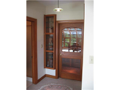 Entry: Brown Co rubble sandstone with channel rustic cedar siding, complimented by fiberglass entry door with bevel glass creates a warm invitation into the lock off foyer. Poplar woodwork, extensive windows, and south facing back elevation for passive so