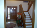 Entry: Two story grand foyer. Hardwood stairs. Tiled floor. Stained ww. Oversized casings and fluted jambs. Powder 1/2 bath. Natural light from window above and door sidelight. Wall space design for furniture decor. Large C/O into dine & family rms.