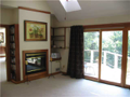 Hearth Room: Hardwood flooring exist under the carpet shown. Fireplace from great room is two way. Owner currently uses great room as grand dining area. Every room with slider glass doors to deck or walk out with lake view. All ceilings raised w skylights
