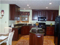 Kitchen: Corner windows above angle sink for wooded lake view and total schmaltz! Want to feel good every morning? Run your hand over quality cherry cabinets and slick granite. Slide your socks or slippers over 3/4" solid oak hardwood floors. Feel rich? B