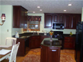 Kitchen: Corner windows above angle sink for wooded lake view and total schmaltz! Want to feel good every morning? Run your hand over quality cherry cabinets and slick granite. Slide your socks or slippers over 3/4" solid oak hardwood floors. Feel rich? B