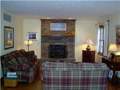 Living Room: Passage from kitchen, foyer, or an invitation from dining room cause a gathering location to be central and integral to all interactive living areas of the main level. Full brick faced fireplace w hearth, hardwood floors, and natural light co