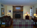 Living Room: Passage from kitchen, foyer, or an invitation from dining room cause a gathering location to be central and integral to all interactive living areas of the main level. Full brick faced fireplace w hearth, hardwood floors, and natural light co