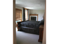 Master Bedroom: A lake view from up top, in the clouds. Watch the early morning burn off. Fireside in the evening. Neutral decor. Adjacent her private bath and closet. Down the hall to his bath and closet.