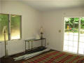 Master Bedroom: Sloped ceiling, exit access to patio, cross ventilation casement windows, hardwood floor. Nice space. Beautiful views from bed and bath
