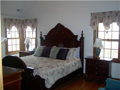 Master Bedroom: Hardwood floor. Raised ceiling. Corner glass to lake view. Walk in closet. Ceramic tiled floor in master bath. Upper level privacy.