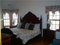 Master Bedroom: Hardwood floor. Raised ceiling. Corner glass to lake view. Walk in closet. Ceramic tiled floor in master bath. Upper level privacy.